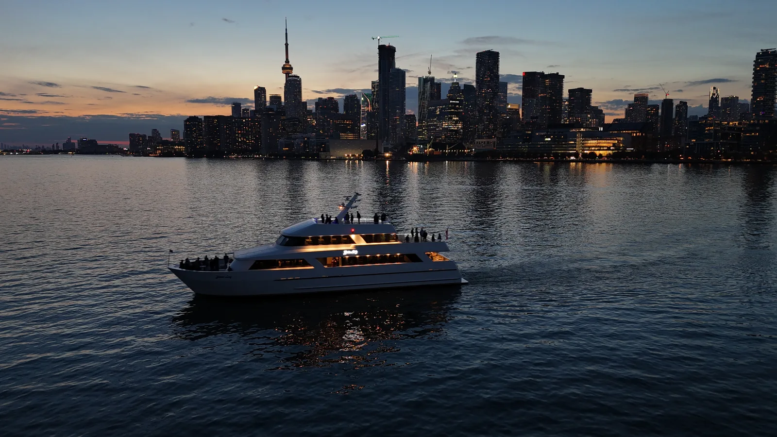 Yankee Lady cruising Toronto Harbour beneath the CN Tower at sunset