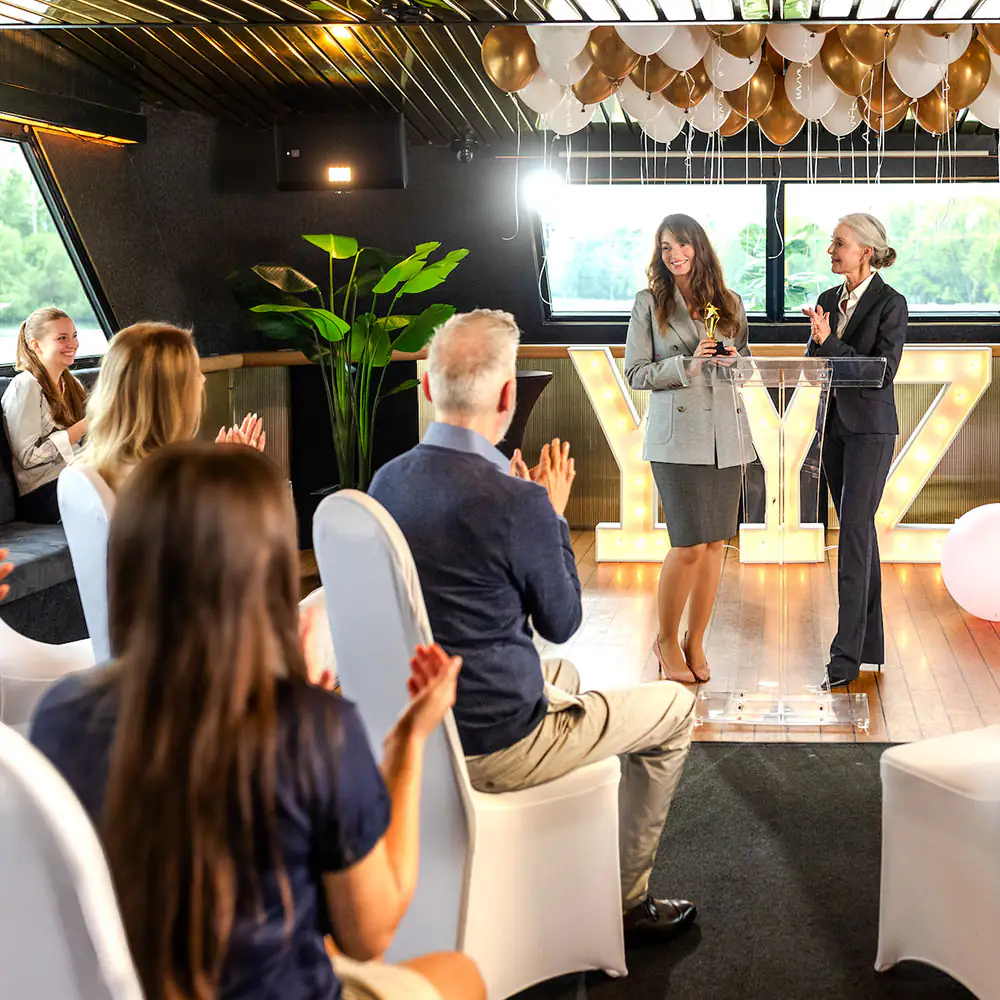 Guests applauding a presentation in the main salon
