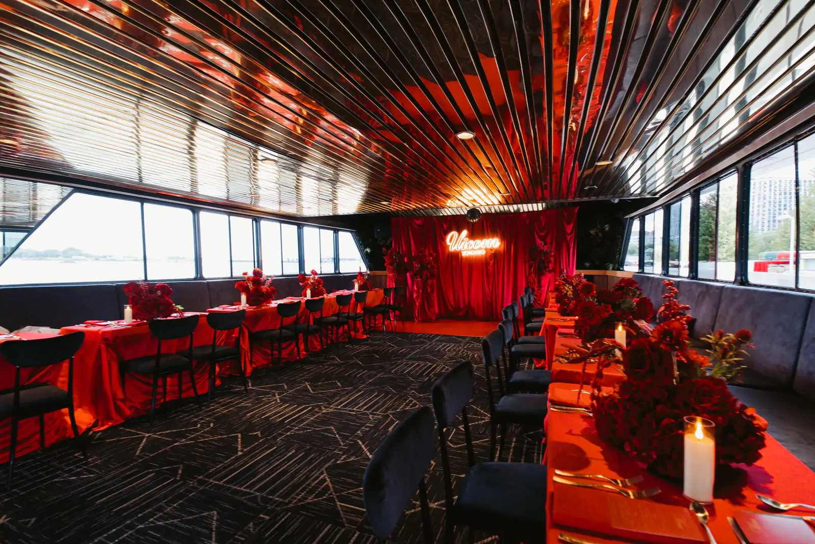 Red event decor and dining tables in the main salon