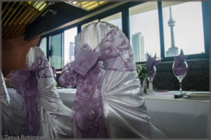Chair covers with lavender bows.