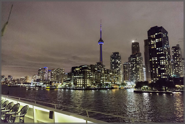 Toronto skyline and the CN Tower while cruising the harbour at night.