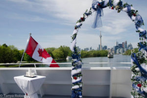 View of the Toronto skyline through a wedding arch on the deck of the cruise ship Yankee Lady IV.