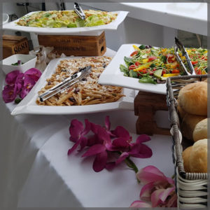 Buffet items of pasta, caesar salad and mixed house salad.