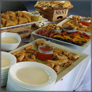 Variety of appetizers like fried samosas, spring rolls and roasted vegetables.