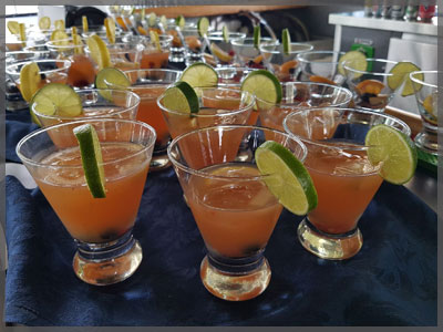 Fruit drinks lined up with slice of lime.