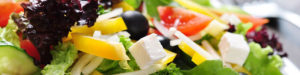 Leaf lettuce, yellow peppers, black olives, tomatoes and feta cheese mixed salad.