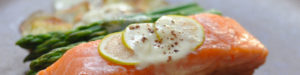 Poached salmon and asparagus with lemon slices.
