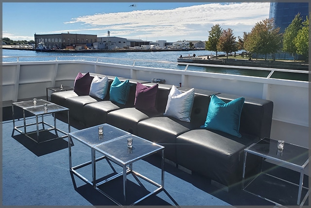 Sitting area for corporate cruise with rental sofa and cushions.